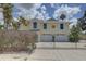 Charming two-story home with a two car garage, coastal landscaping and a security gate at driveway at 9914 Alavista Dr, Gibsonton, FL 33534