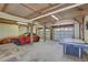 Garage featuring a red car, picnic table, and air hockey table at 9914 Alavista Dr, Gibsonton, FL 33534