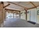 Spacious lower-level space with exposed wooden beams and a door to the water at 9914 Alavista Dr, Gibsonton, FL 33534