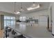 The kitchen offers white cabinetry, an eat-in island with bar stool seating and stainless appliances at 9914 Alavista Dr, Gibsonton, FL 33534
