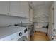 Convenient laundry room with washer, dryer, built in shelving and storage space at 9914 Alavista Dr, Gibsonton, FL 33534