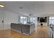 Bright living room with wood floors, built in entertainment center, and sliding glass doors to deck at 9914 Alavista Dr, Gibsonton, FL 33534