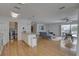 Spacious open concept living area with a kitchen, Gathering and dining area; wood floors throughout at 9914 Alavista Dr, Gibsonton, FL 33534