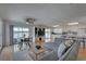 Open-concept living room with water view, dining area, and modern furnishings creating a bright and inviting space at 9914 Alavista Dr, Gibsonton, FL 33534