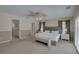 Spacious bedroom features a ceiling fan, bench and ensuite bathroom at 9914 Alavista Dr, Gibsonton, FL 33534