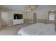 Spacious bedroom features a ceiling fan, TV and ensuite bathroom at 9914 Alavista Dr, Gibsonton, FL 33534