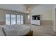 Spacious bedroom features a ceiling fan, TV, sliding doors and ensuite bathroom at 9914 Alavista Dr, Gibsonton, FL 33534