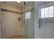 Luxurious walk-in shower featuring multiple showerheads, a built-in seat, and elegant tile design at 9914 Alavista Dr, Gibsonton, FL 33534