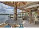Picturesque tiki bar next to a waterway featuring seating and a covered roof at 9914 Alavista Dr, Gibsonton, FL 33534