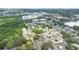 This property offers a picturesque aerial view of a quiet residential area with mature trees at 1003 Carol Ann Pl, Dunedin, FL 34698