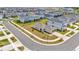 Areal view of residential street with lush green lawns and sidewalks in front of grey, two-story single-Gathering homes at 10360 Honeysuckle Vine Cir, Riverview, FL 33578