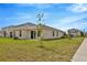 Expansive backyard with lush lawn, sliding glass doors, and a view of neighboring homes in a tranquil setting at 10360 Honeysuckle Vine Cir, Riverview, FL 33578