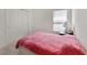 Cozy bedroom with pink blanket, closet and window offering ample light at 10360 Honeysuckle Vine Cir, Riverview, FL 33578