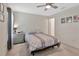 Relaxing bedroom featuring a ceiling fan, comfortable bed, and neutral decor at 10360 Honeysuckle Vine Cir, Riverview, FL 33578