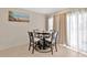 Cozy dining area featuring a round table with seating for four and natural light at 10360 Honeysuckle Vine Cir, Riverview, FL 33578