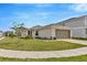 Charming single-story home with a well-manicured lawn and two-car garage in a Gathering-friendly neighborhood at 10360 Honeysuckle Vine Cir, Riverview, FL 33578