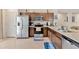 Well-equipped kitchen with stainless steel appliances, dark wood cabinets, and ample counter space at 10360 Honeysuckle Vine Cir, Riverview, FL 33578