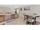 Well-lit kitchen with stainless steel dishwasher and dining area with seating for four at 10360 Honeysuckle Vine Cir, Riverview, FL 33578