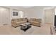 Inviting living room featuring neutral tones, two sofas, and a dark wood coffee table at 10360 Honeysuckle Vine Cir, Riverview, FL 33578