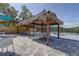 Inviting outdoor seating area featuring tiki huts, tables, and chairs, perfect for relaxing and socializing at 10509 Waterview Ct, Tampa, FL 33615