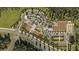 Aerial view of gardens with multiple buildings, a parking lot and surrounding green areas at 10853 Rustic Eve Ct, Land O Lakes, FL 34638