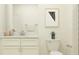Well-lit bathroom with white vanity, modern art, and silver fixtures at 10853 Rustic Eve Ct, Land O Lakes, FL 34638