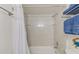 Bathroom showcasing tile shower, neutral decor, and functional towel racks at 1137 King Arthur Ct # 501, Dunedin, FL 34698