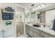 Well-lit bathroom featuring a sink and vanity, toilet, and combined tub and shower at 1137 King Arthur Ct # 501, Dunedin, FL 34698