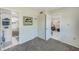 Bedroom shows gray carpet and doorways to the bathroom and a separate room with tile floor at 1137 King Arthur Ct # 501, Dunedin, FL 34698