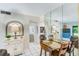 Bright dining area featuring tile floors, adjacent living area, and kitchen views, creating a comfortable atmosphere at 1137 King Arthur Ct # 501, Dunedin, FL 34698