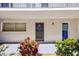 A charming condo entrance adorned with vibrant flora and crisp white exterior, creating an inviting welcome at 1137 King Arthur Ct # 501, Dunedin, FL 34698