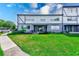 Two-story home with manicured lawn at 1137 King Arthur Ct # 501, Dunedin, FL 34698