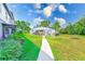 Exterior shot showing well-maintained landscaping and a path to the building's entry at 1137 King Arthur Ct # 501, Dunedin, FL 34698