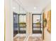 Condo foyer with mirrored closet doors, tile flooring, and views to the exterior, creating a bright and welcoming space at 1137 King Arthur Ct # 501, Dunedin, FL 34698
