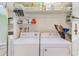 Laundry Room features washer, dryer, and overhead shelves at 1137 King Arthur Ct # 501, Dunedin, FL 34698