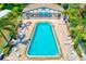 Aerial view of the community pool surrounded by plenty of lounge chairs for residents to enjoy at 1137 King Arthur Ct # 501, Dunedin, FL 34698