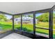 Screened in porch provides beautiful views of the yard and community pool at 1137 King Arthur Ct # 501, Dunedin, FL 34698