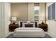 Cozy bedroom featuring a comfortable bed, neutral tones, and natural light from a window at 11767 Brae Way, Dade City, FL 33525