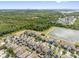 An aerial view of a community surrounded by lush trees and a shimmering lake at 12028 Citrus Leaf Dr, Gibsonton, FL 33534