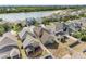 Aerial view of beautiful homes next to the lake featuring lush landscaping and cozy backyards at 12028 Citrus Leaf Dr, Gibsonton, FL 33534