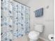 A full bathroom featuring a toilet and shower with curtain at 12028 Citrus Leaf Dr, Gibsonton, FL 33534