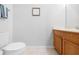 Bathroom featuring a modern toilet, neutral wall color, and wood vanity at 12028 Citrus Leaf Dr, Gibsonton, FL 33534