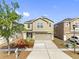 Traditional two-story home with neutral color palette, landscaping, and attached two-car garage at 12028 Citrus Leaf Dr, Gibsonton, FL 33534