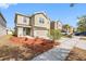 Inviting two-story home with a lush lawn, landscaped garden, and attached two-car garage at 12028 Citrus Leaf Dr, Gibsonton, FL 33534