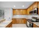 Bright kitchen with light wood cabinets, stainless steel appliances, and white countertop at 12028 Citrus Leaf Dr, Gibsonton, FL 33534