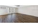 Open living room with hardwood floors, ceiling fan, and natural light from the window at 12028 Citrus Leaf Dr, Gibsonton, FL 33534