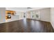 Spacious open-concept room with hardwood floors connecting the living room and kitchen at 12028 Citrus Leaf Dr, Gibsonton, FL 33534