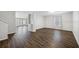 Open-concept living space featuring hardwood floors, neutral tones, and large windows at 12028 Citrus Leaf Dr, Gibsonton, FL 33534