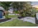 Large backyard featuring mature trees, mulch beds, and an open patio at 1211 64Th Nw St, Bradenton, FL 34209