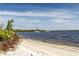 Sandy beach view with calm waters and boats, offering a relaxing coastal experience at 1211 64Th Nw St, Bradenton, FL 34209